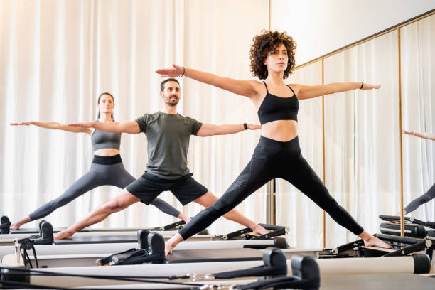 3 people on pilates reformer