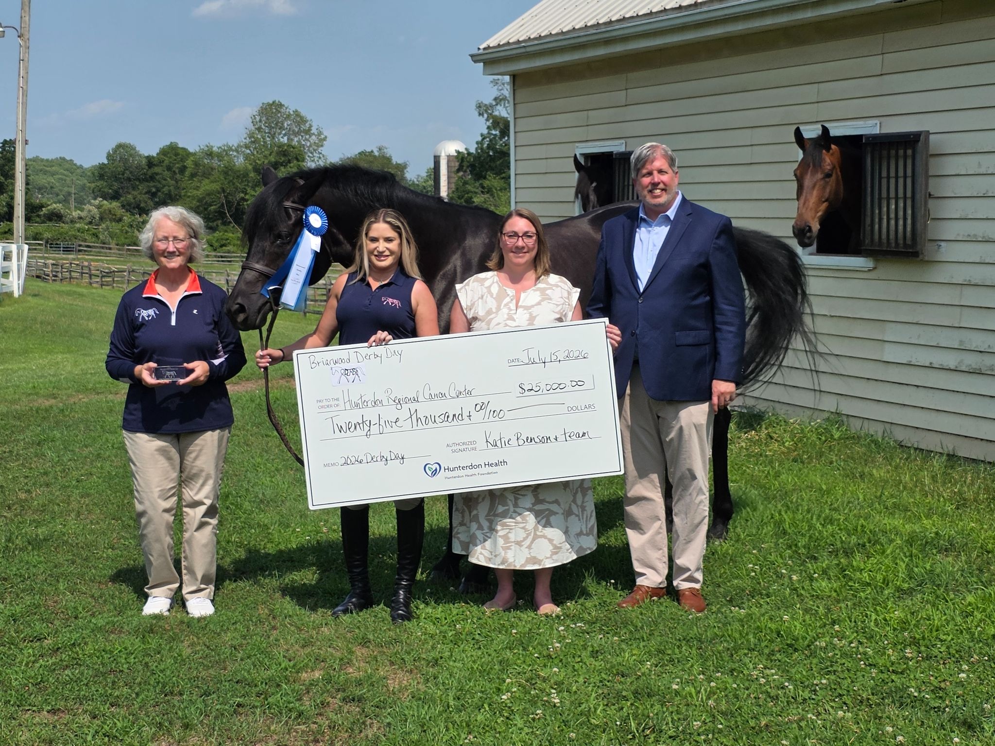 Katie Benson and Lauren Gould present check to Hunterdon Health Foundation