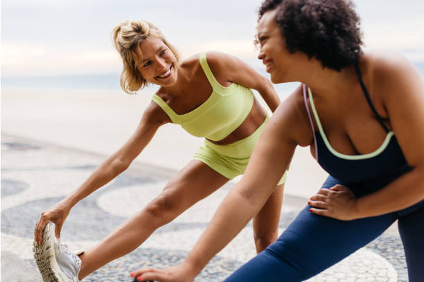 two women stretching on beach