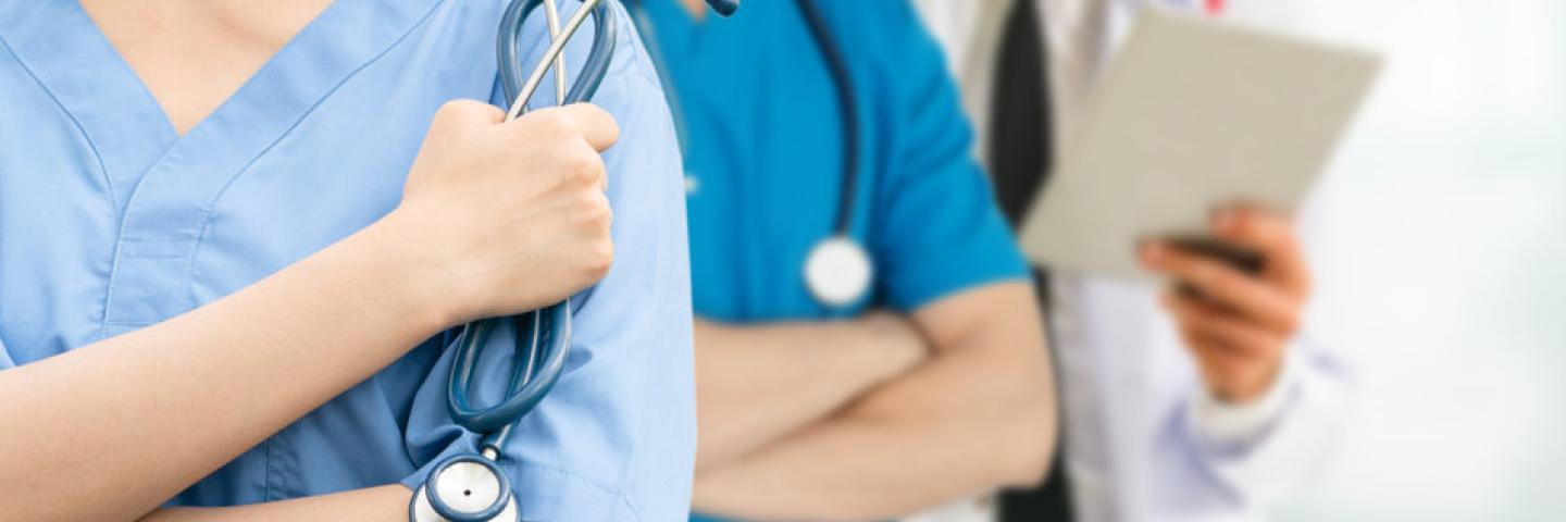 Photo of doctors and nurses standing in a row no faces showing