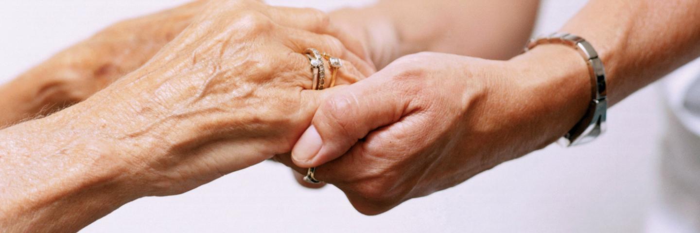 Patient holding hands with a nurse