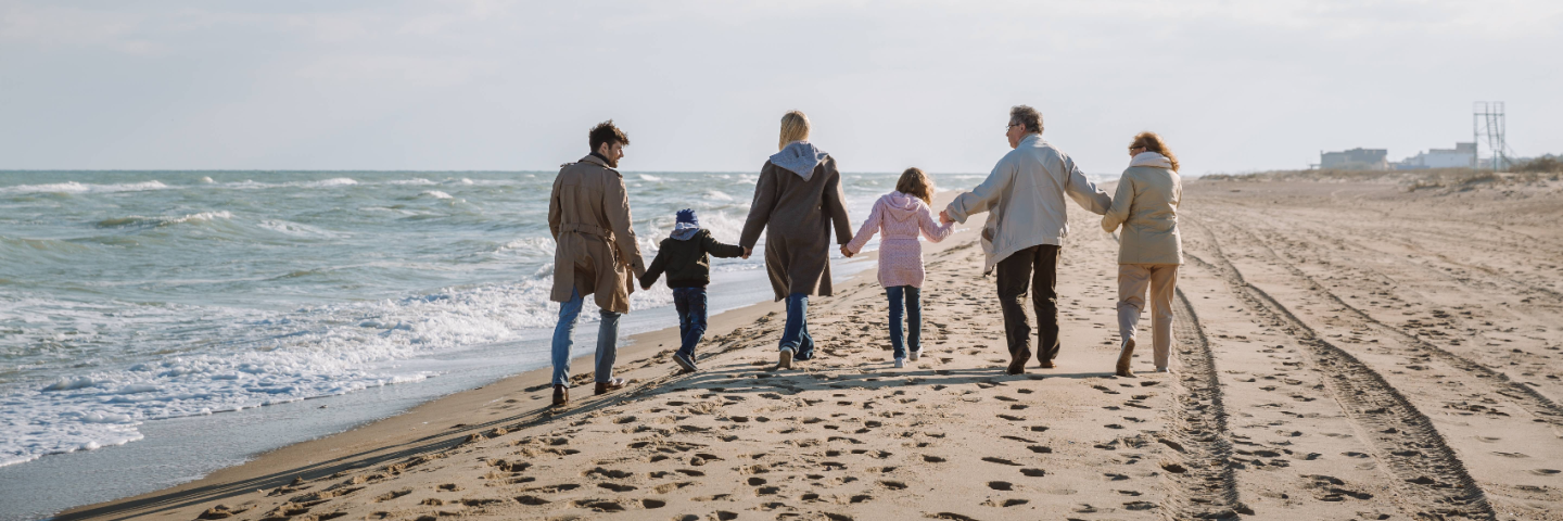 Family holding hands on a beach
