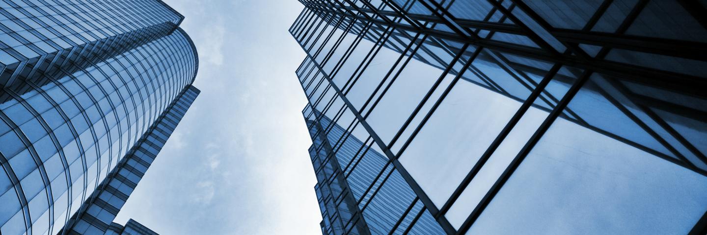 view from ground of tall glass highrise buildings