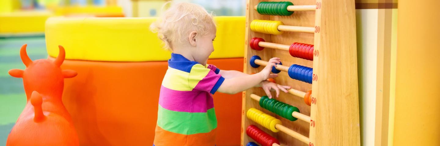 toddler boy playing with abacus