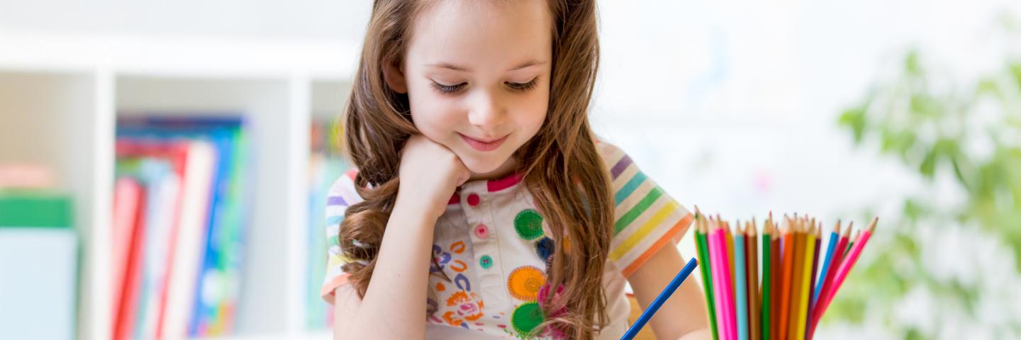 Young girl coloring at desk