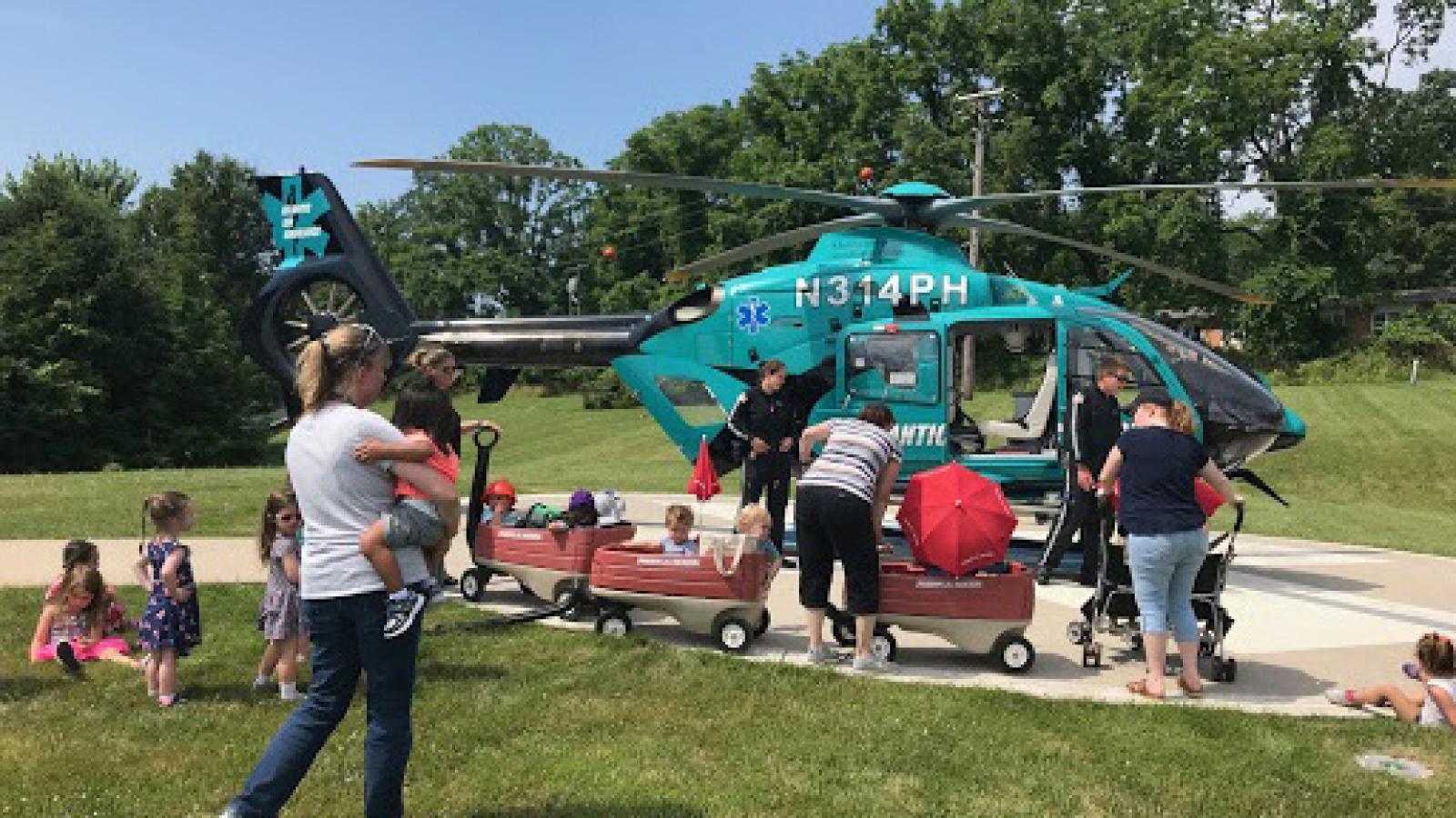 Children get a tour of a helicopter.