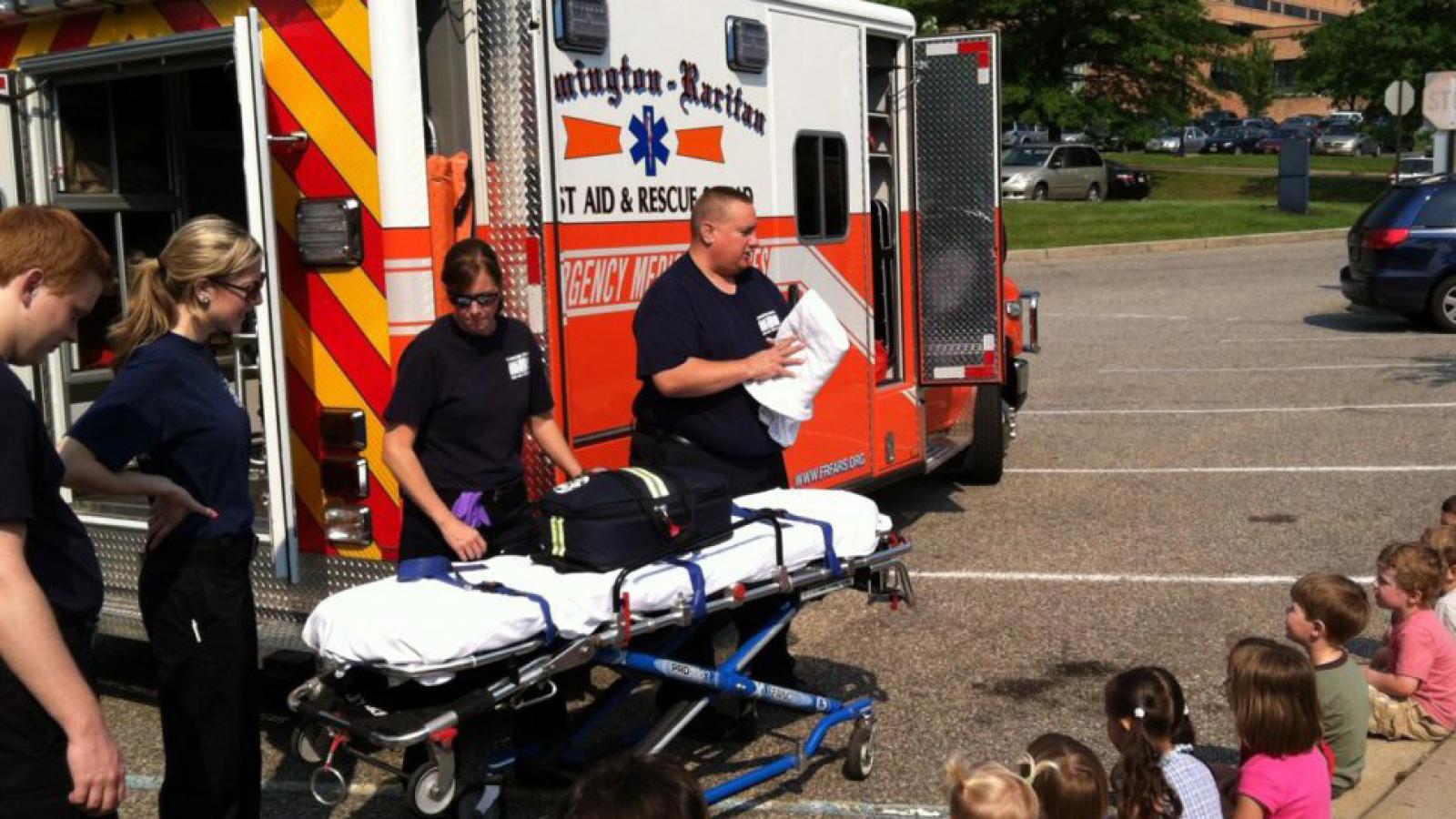 Children get a tour of an ambulance.