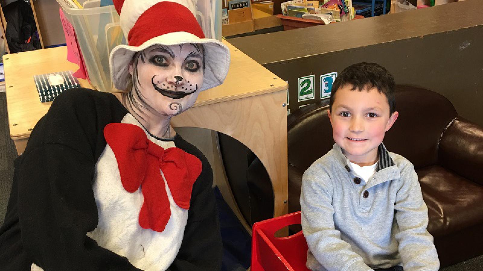 The Cat in the Hat visits with a child.
