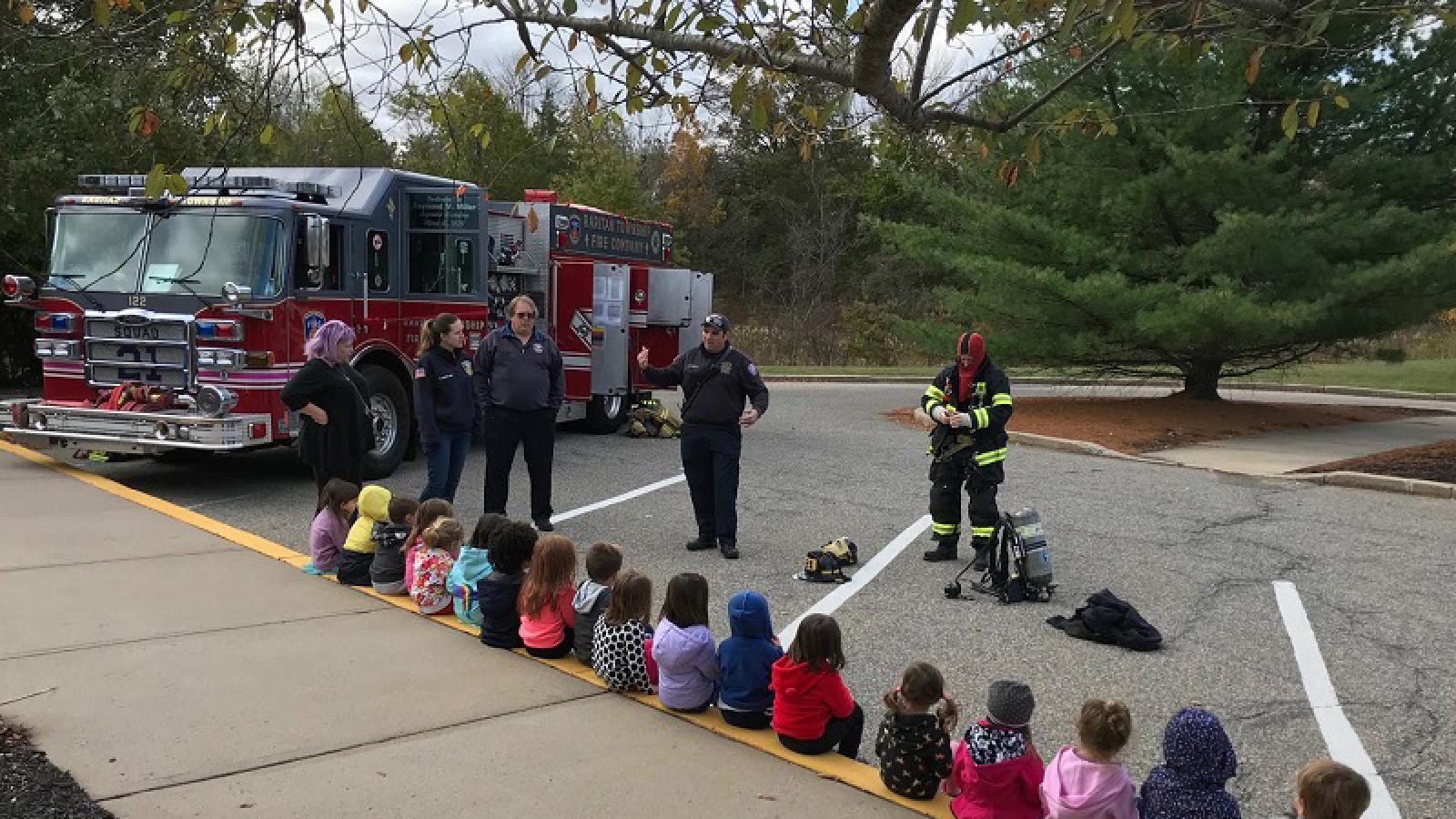 A fireman educates the children on fire safety and a tour of the fire truck.