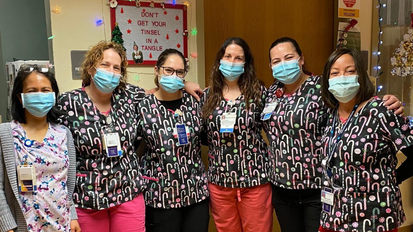 A group of nurses gather.