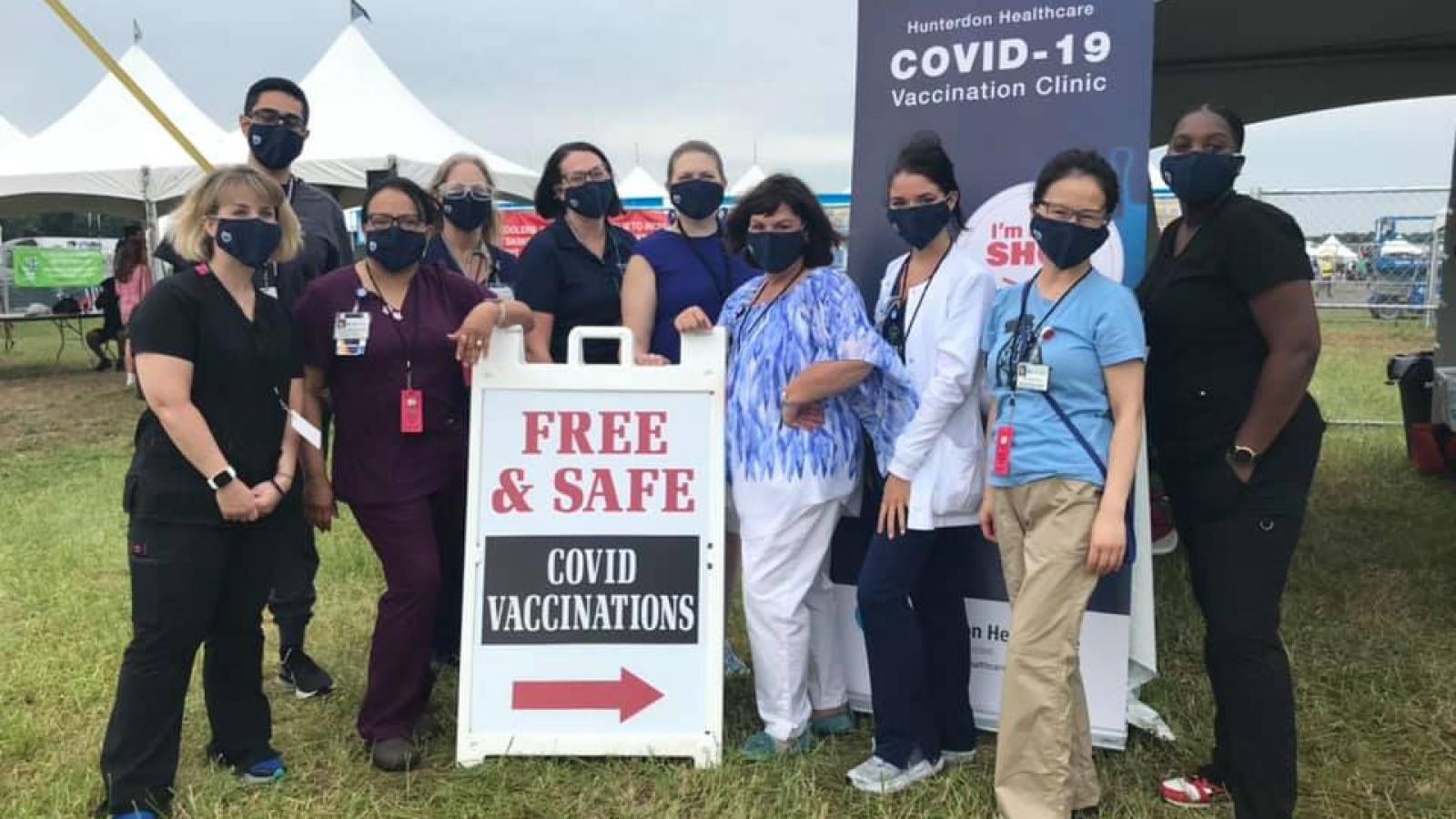 Employees gather for a picture at a COVID-19 Vaccine Clinic.