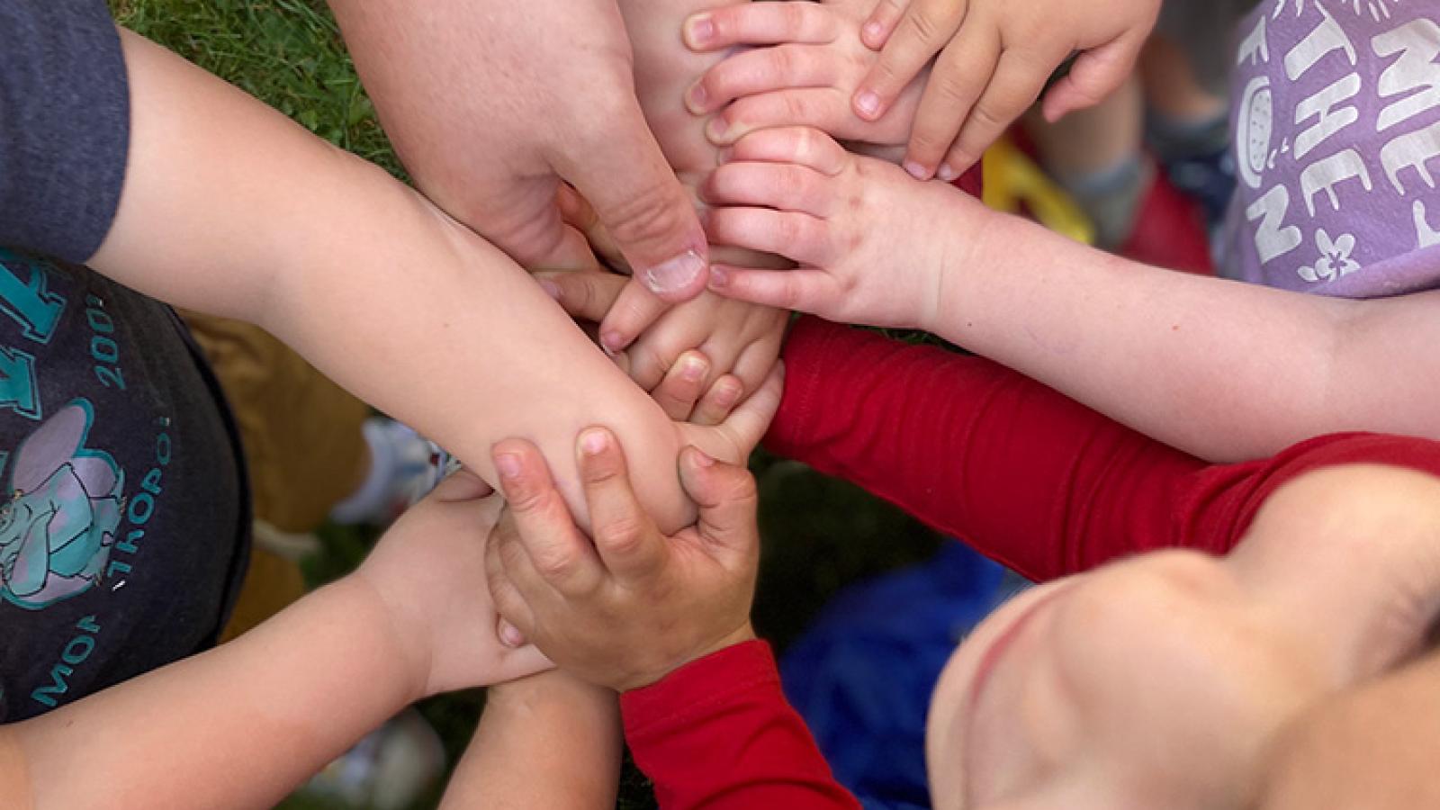 Children bringing hands together