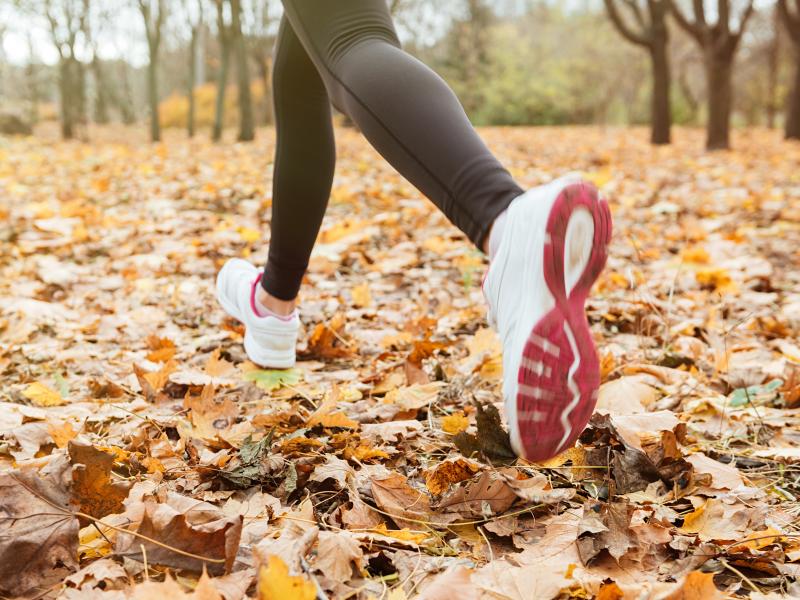Woman walking on fall leaves