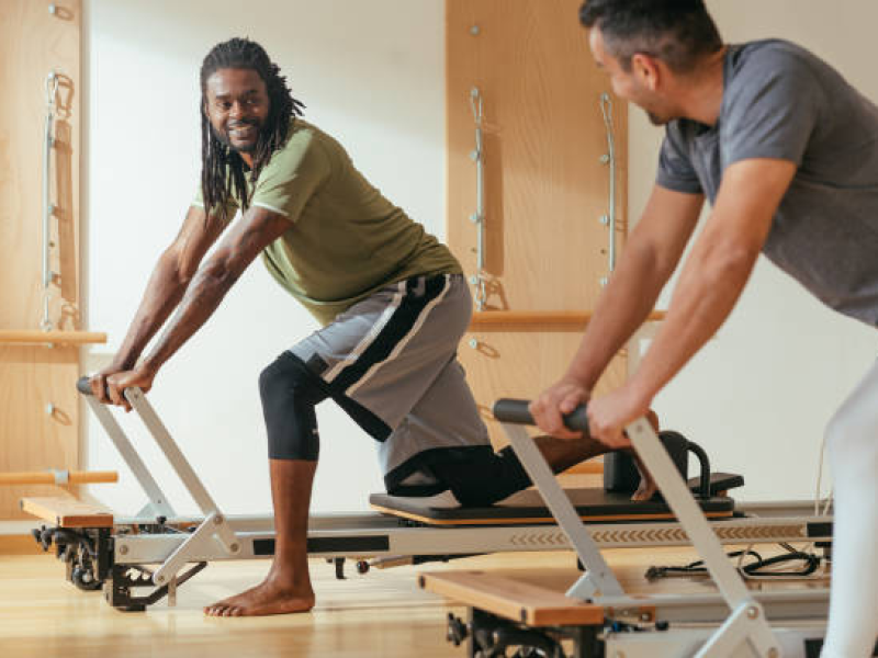 Two men on Pilates reformer