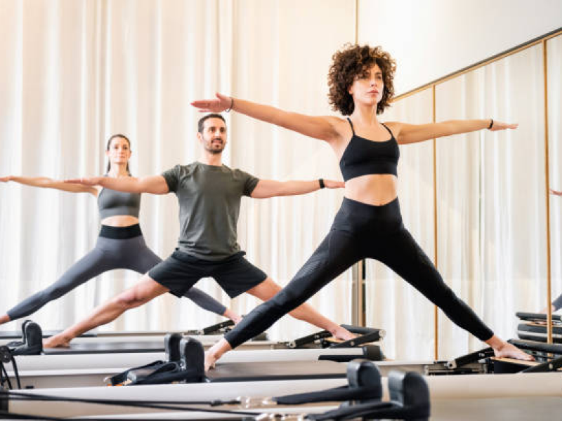3 people Standing on Pilates Reformer 