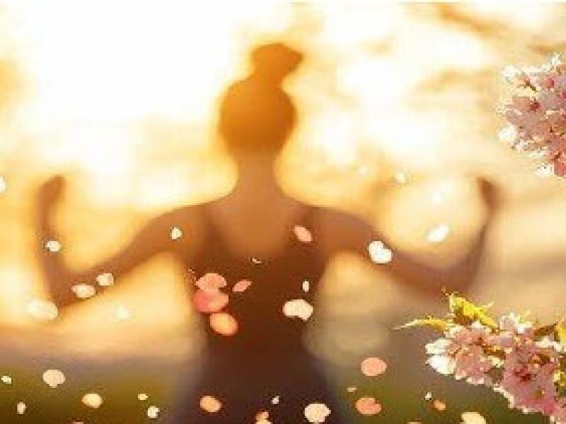 Woman meditating outside in sunlight