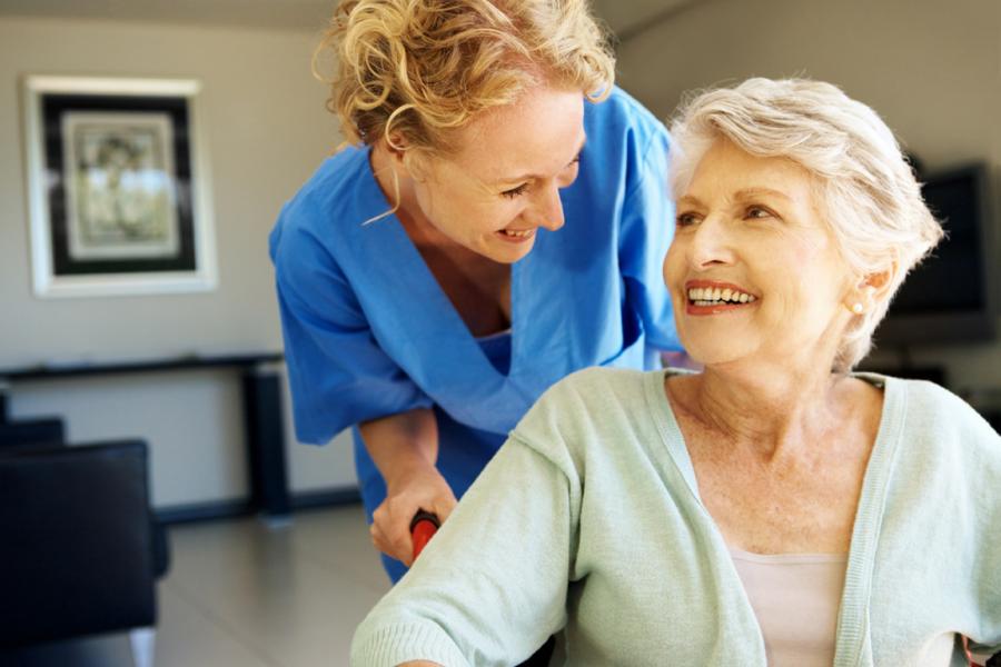 Nurse looking at patient in wheelchair