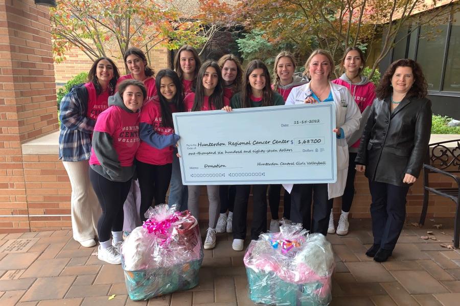 Volleyball Team Members present check to HRCC