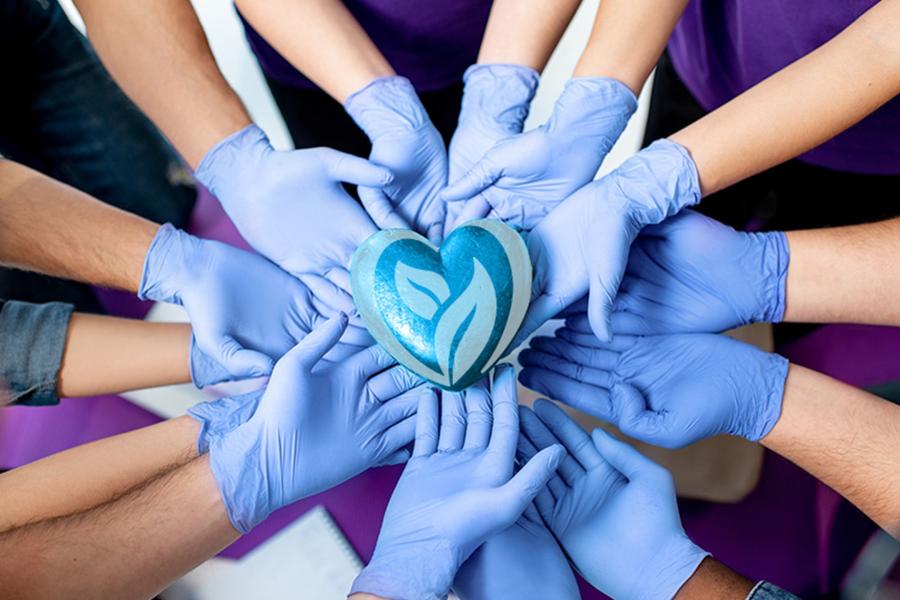Gloved hands holding heart logo
