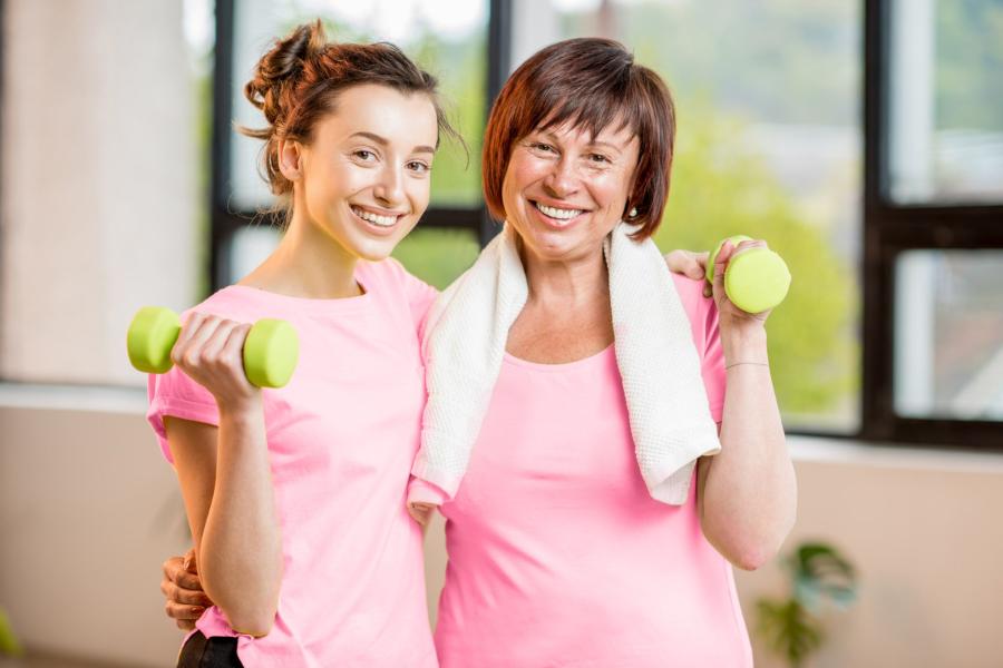 Mom and daughter lifting weights