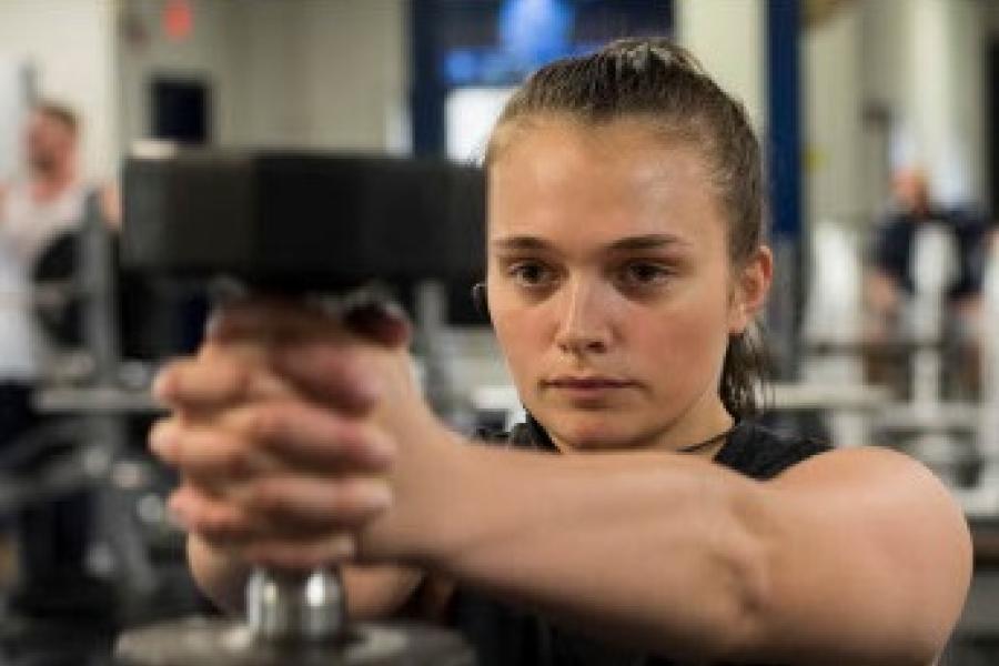 young woman holding a hand weight