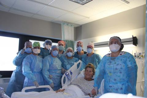 Nursing Staff pose for a photo with one of their patients who was recovering from COVID-19