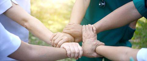 Nurses linking arms.