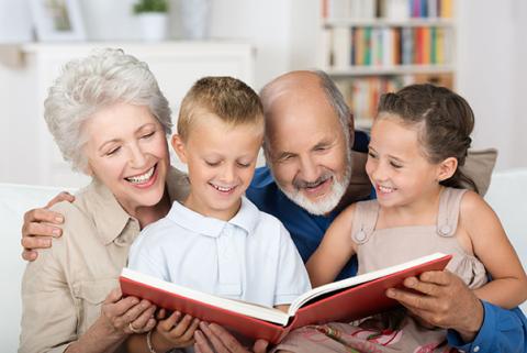 Photo of Grandparents reading to grandkids.