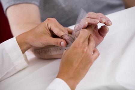 Occupational Therapist checking wrist flexibility 