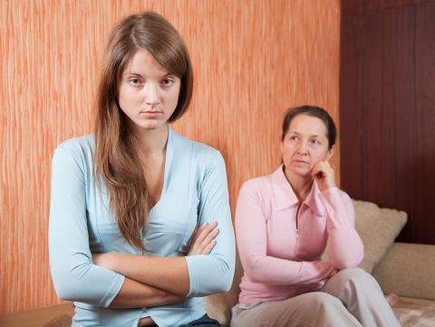 Mother looks at daughter worried while daughter looks angry