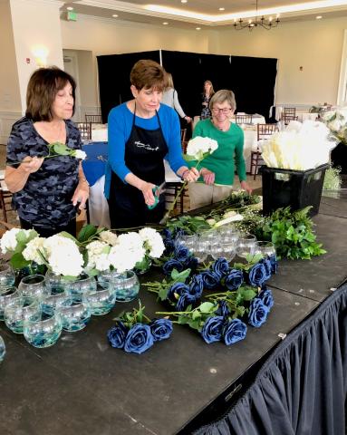 Foundation Auxiliary Members prep flower arrangements for an event