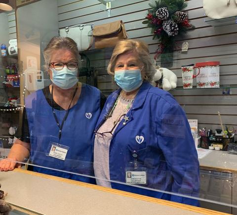 Two volunteers enjoy volunteering in the Lobby Shop at HMC.
