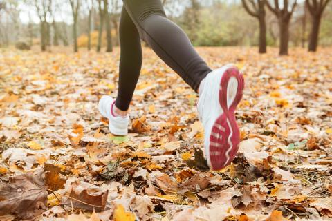 Woman walking on fall leaves