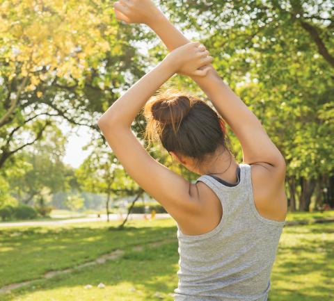 Woman stretching outdoors - mental wellness