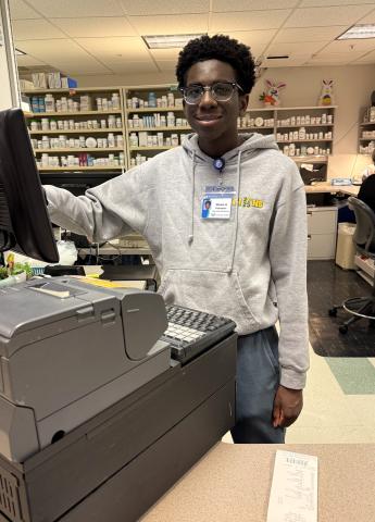 High School student volunteer helping in the pharmacy