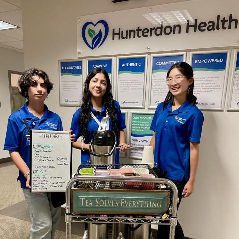 Volunteers pose with their tea cart.